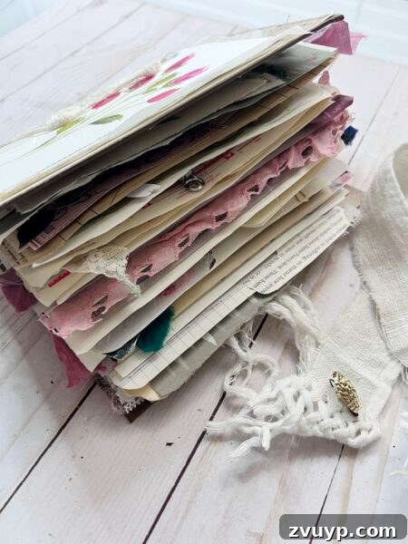 Ingrid Carlsen's Petal & Sip Junk Journal 4 Side profile of a full junk journal, showcasing its thick, embellished pages and layered design