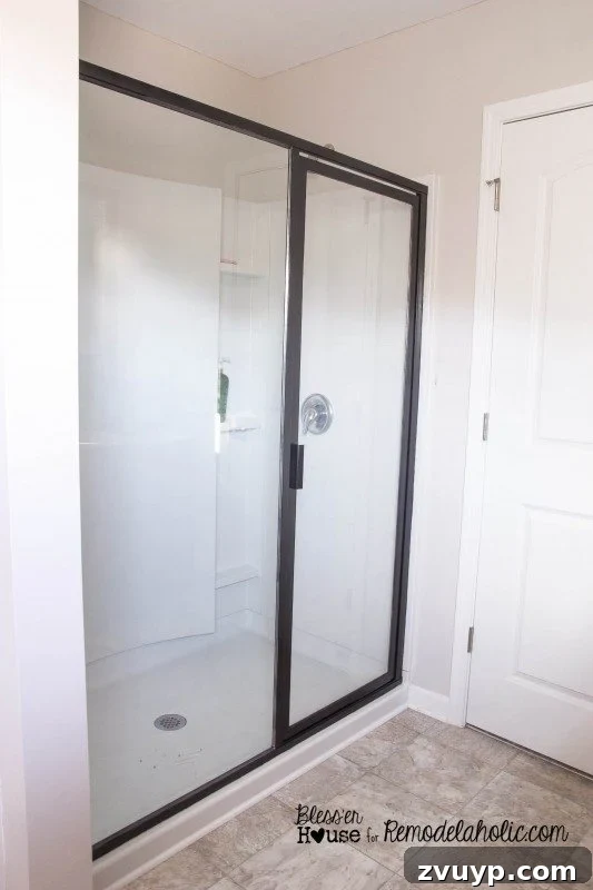 Beautifully painted shower door frame, looking sleek and industrial after touch-ups.