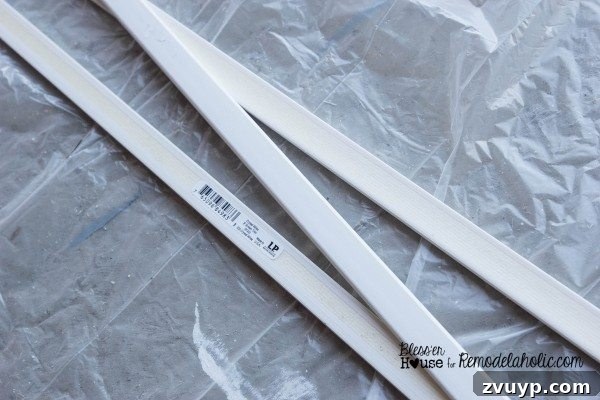 Cutting polystyrene moulding pieces to create vertical grid sections for a shower door.