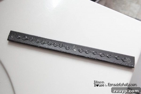 Measuring between vertical moulding pieces to cut horizontal sections for the shower door grid.