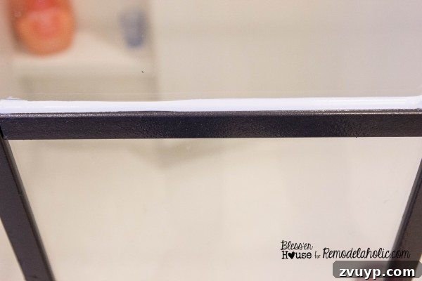 Using a caulk finishing tool to smooth applied clear latex caulk for a neat seal.