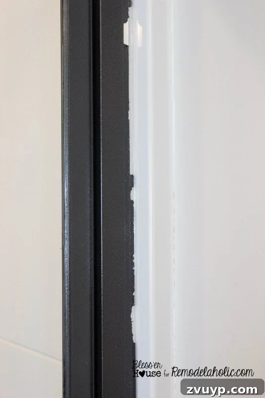 Close-up of peeled paint edge after tape removal, demonstrating the importance of scoring painter's tape.