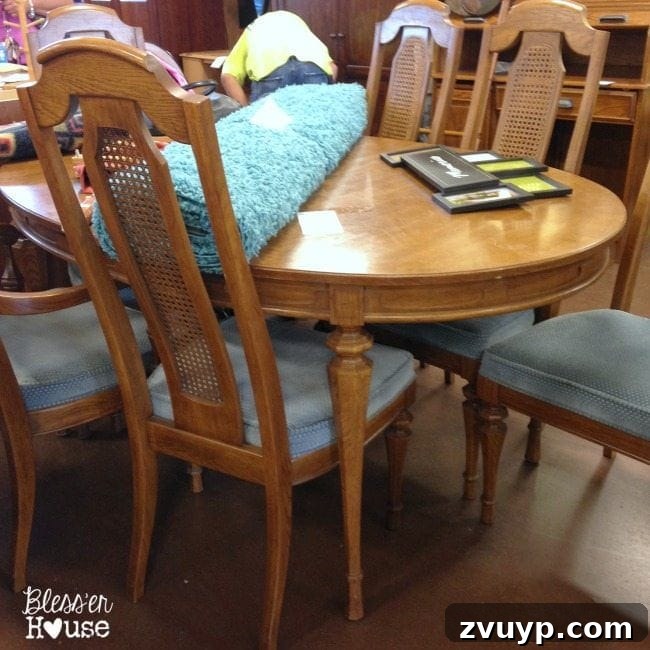 Thrift Like a Pro: Goodwill's Best Kept Secrets 14 A large wooden dining table and chairs set in a Goodwill store.