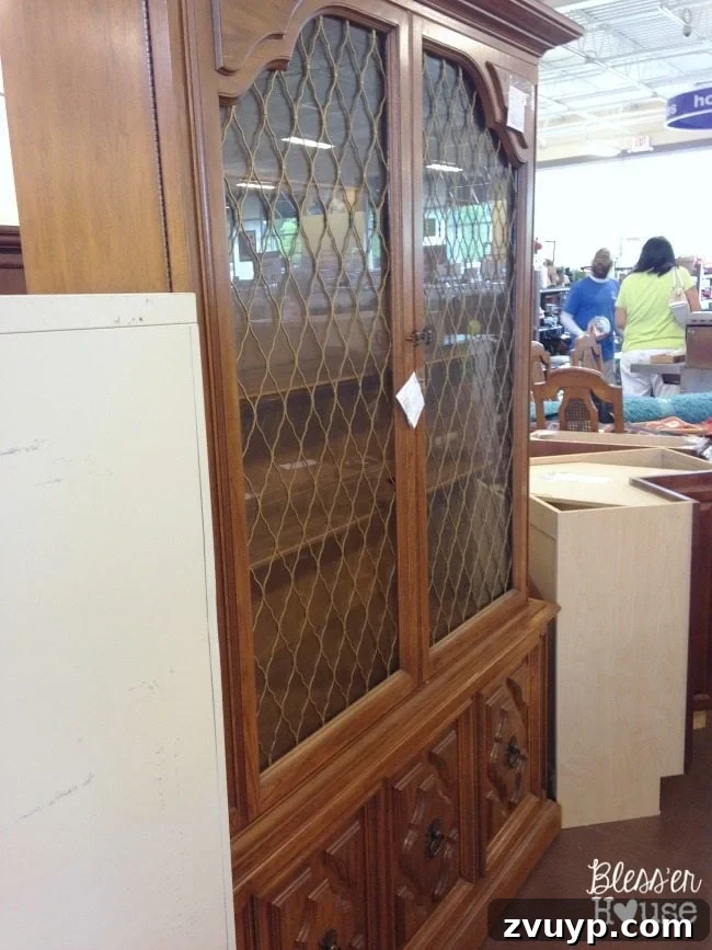Thrift Like a Pro: Goodwill's Best Kept Secrets 15 A china cabinet with quatrefoil details in a Goodwill store.