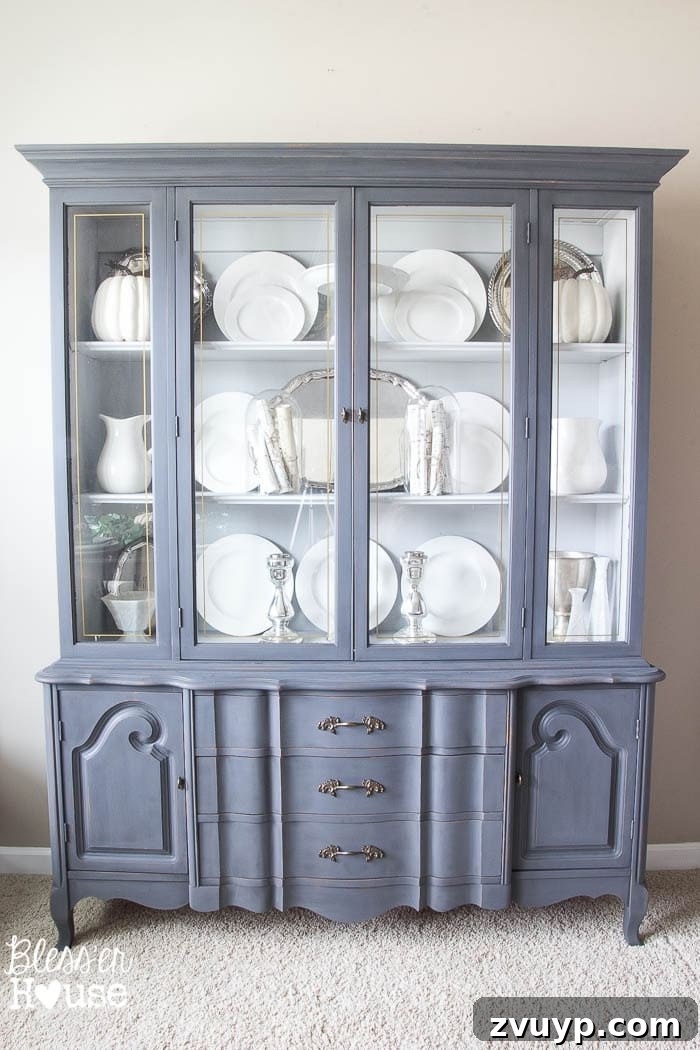 Thrift Like a Pro: Goodwill's Best Kept Secrets 16 A beautifully repainted French Provincial china cabinet, showcasing a thrift store makeover.