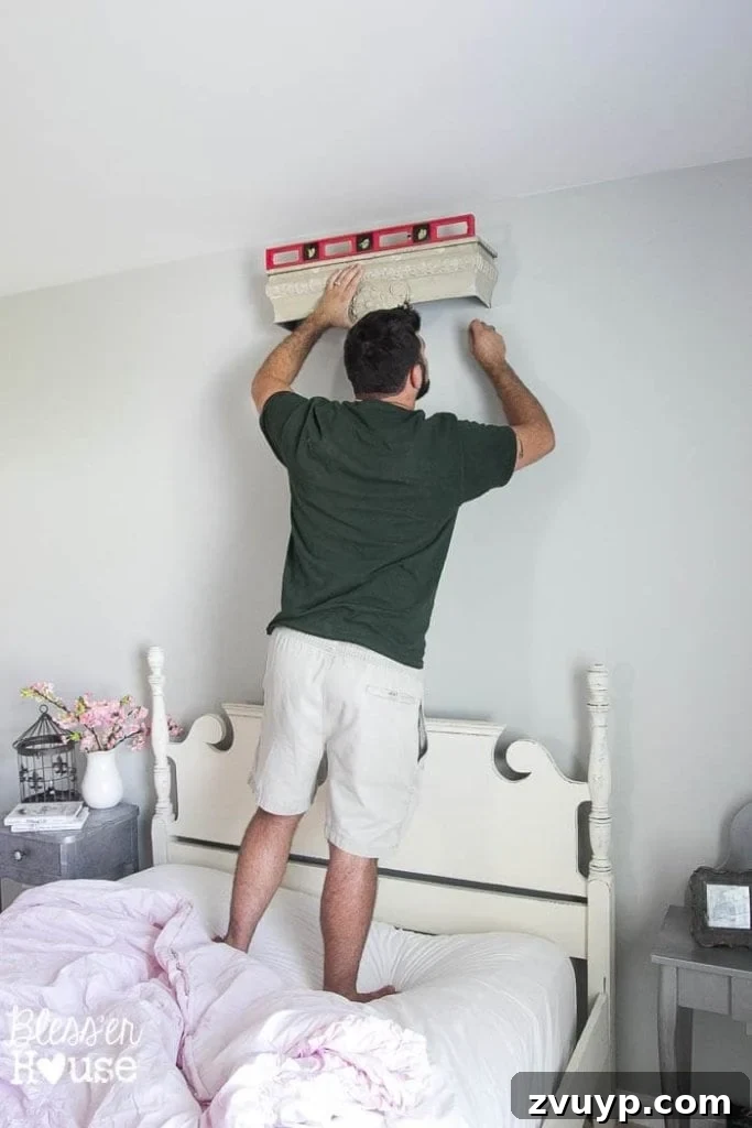 Dreamy Bed Canopy Crown from an Upcycled Shelf 4 DIY Canopy Crown from a Repurposed Shelf: Installing the shelf securely with a level is the first step to creating a magical bedroom canopy.