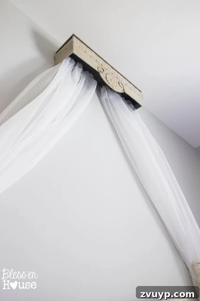 Dreamy Bed Canopy Crown from an Upcycled Shelf 5 DIY Canopy Crown from a Repurposed Shelf: The finished canopy in Olivia's bedroom, showcasing the sheer curtains draped from the repurposed shelf, creating a princess-like feel.