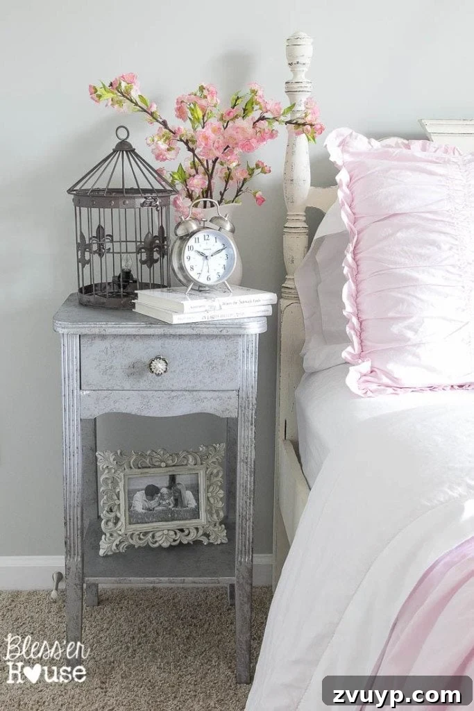 En Pointe Perfection: Her Ballerina Bedroom Makeover 13 Grandfather's antique nightstand revived with aged metallic paint, serving as bedside decor in a girl's room.