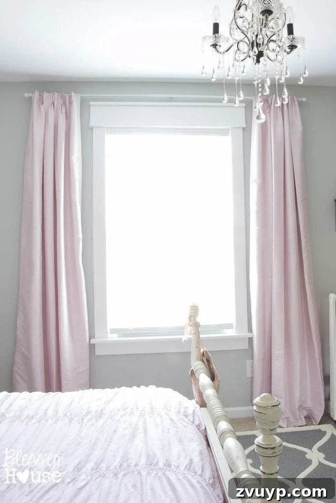 En Pointe Perfection: Her Ballerina Bedroom Makeover 14 Window with DIY trim and blush pink curtains, enhancing space and light in a girl's bedroom makeover.