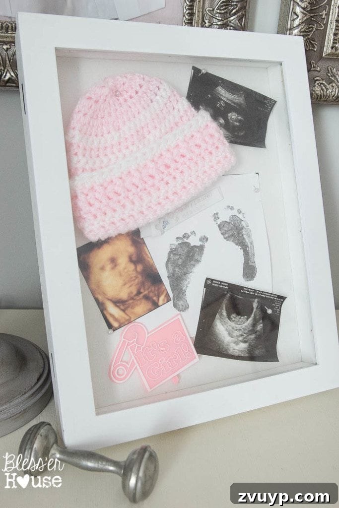En Pointe Perfection: Her Ballerina Bedroom Makeover 19 Shadowbox displaying baby mementos and an antique silver rattle, creating a sentimental vignette in a girl's room.