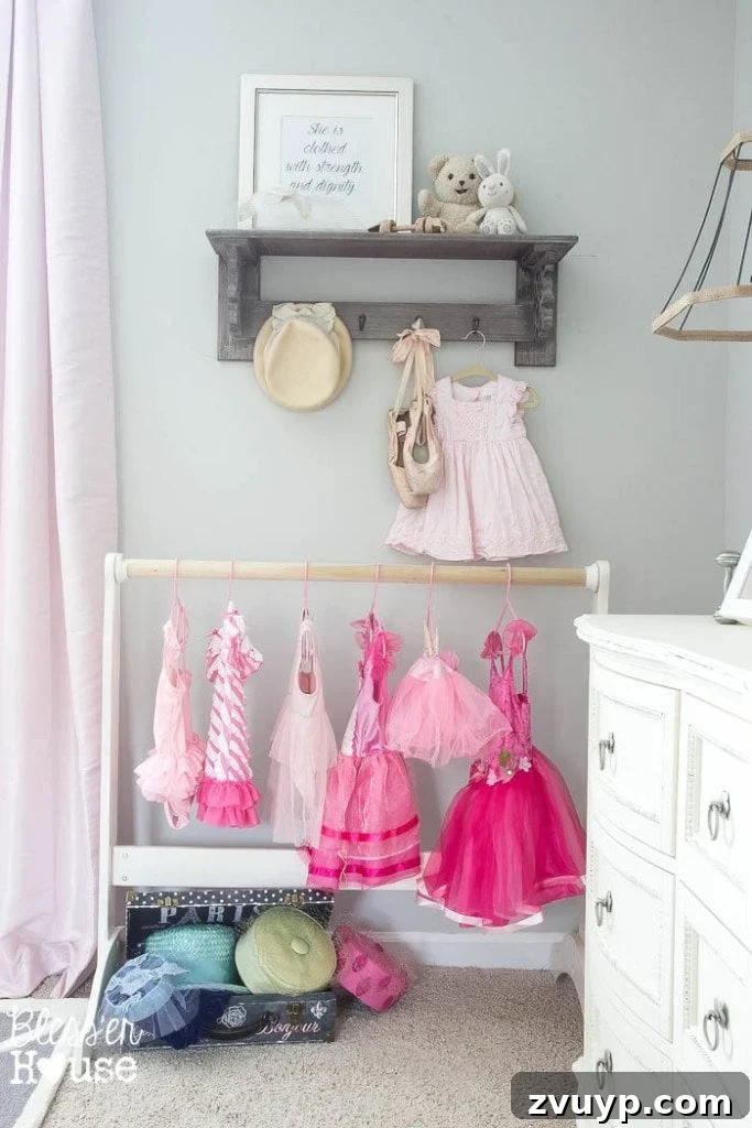 En Pointe Perfection: Her Ballerina Bedroom Makeover 22 Repurposed bassinet stand as a dress-up rack for children's costumes, perfect for a ballerina's room.