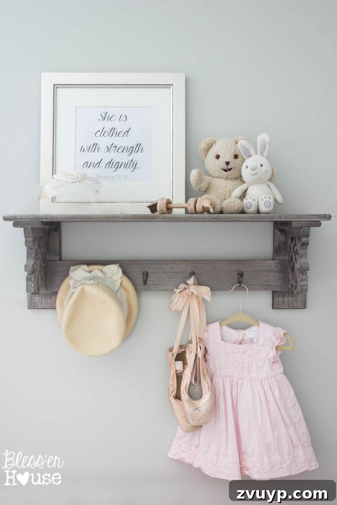 En Pointe Perfection: Her Ballerina Bedroom Makeover 23 Hobby Lobby shelf with decorative items, framed Bible verse, and beloved childhood toys.