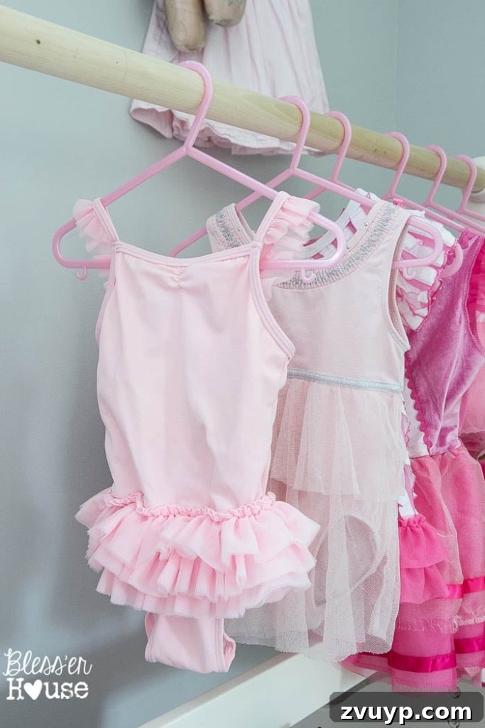 En Pointe Perfection: Her Ballerina Bedroom Makeover 27 Little girl joyfully twirling in a dance dress in her beautifully decorated ballerina bedroom.