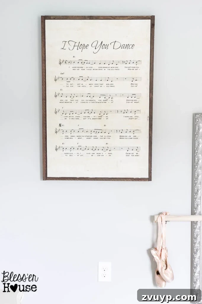 En Pointe Perfection: Her Ballerina Bedroom Makeover 32 Detail shot of the DIY oversized sheet music wooden sign, part of the ballerina bedroom decor.
