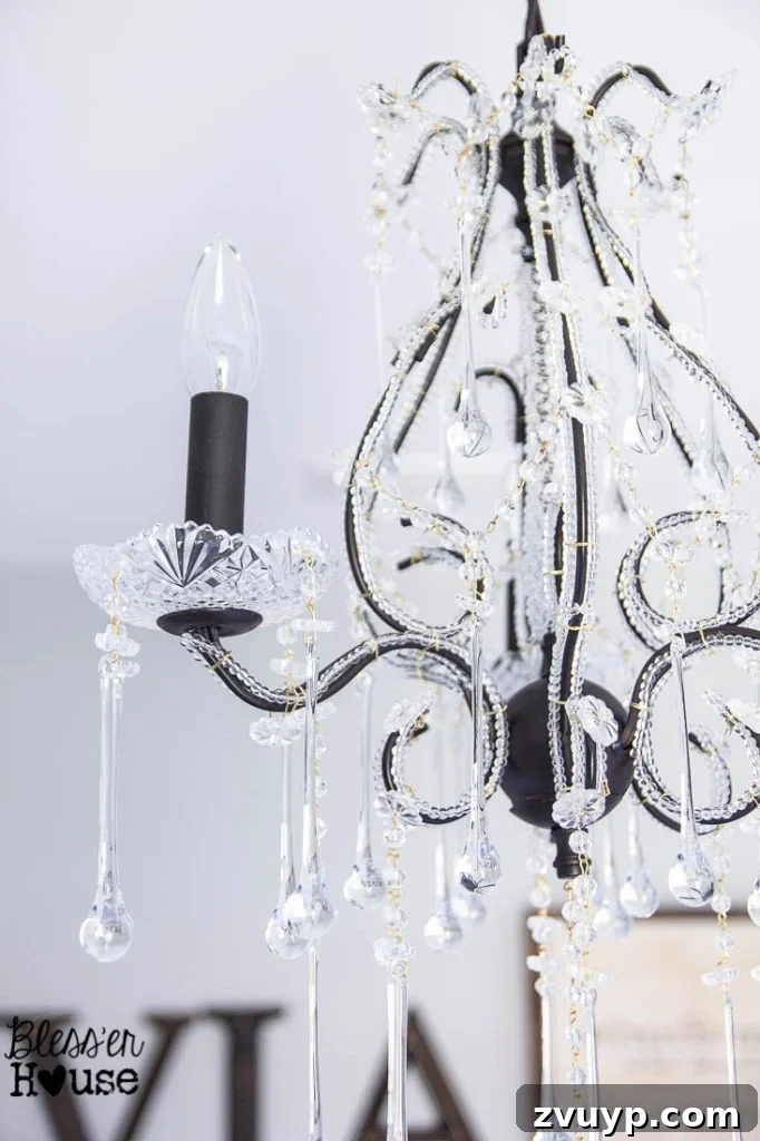 En Pointe Perfection: Her Ballerina Bedroom Makeover 33 Elegant chandelier hanging in a girl's ballerina bedroom, replacing an old IKEA light fixture.