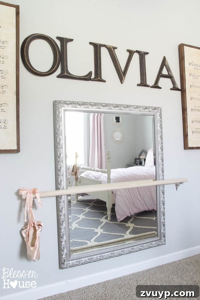 En Pointe Perfection: Her Ballerina Bedroom Makeover 6 DIY Ballet Barre and antique mirror in a ballerina-themed girl's bedroom makeover, perfect for aspiring dancers.