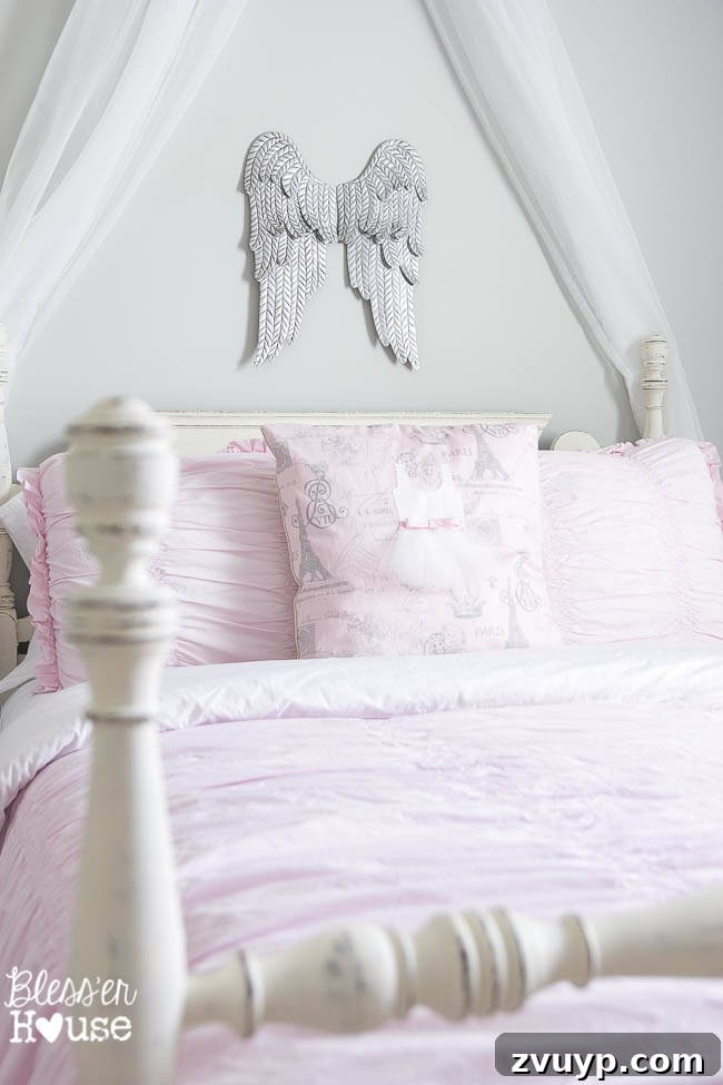En Pointe Perfection: Her Ballerina Bedroom Makeover 9 Aged metal angel wings decor in a charming girl's bedroom, adding a whimsical touch to the decor.