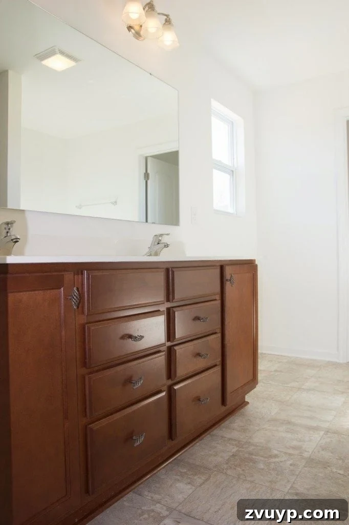 Effortless Cabinet Transformation for Beginners 3 Before and after comparison of old, cherry-stained bathroom cabinets transformed into modern, painted ones.