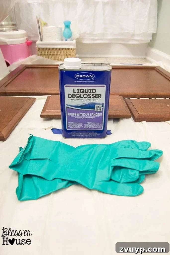 Effortless Cabinet Transformation for Beginners 9 Cleaning cabinet surfaces with liquid deglosser and filling old hardware holes.