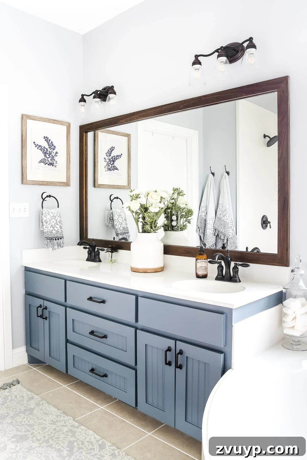 builder grade mirror with DIY wood mirror frame above a double bathroom vanity