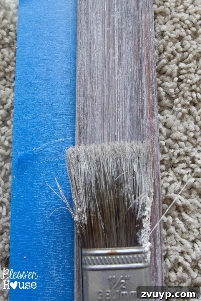 Vintage Book Page Botanical Creations 5 Close-up of liming wax being applied to a wooden frame.