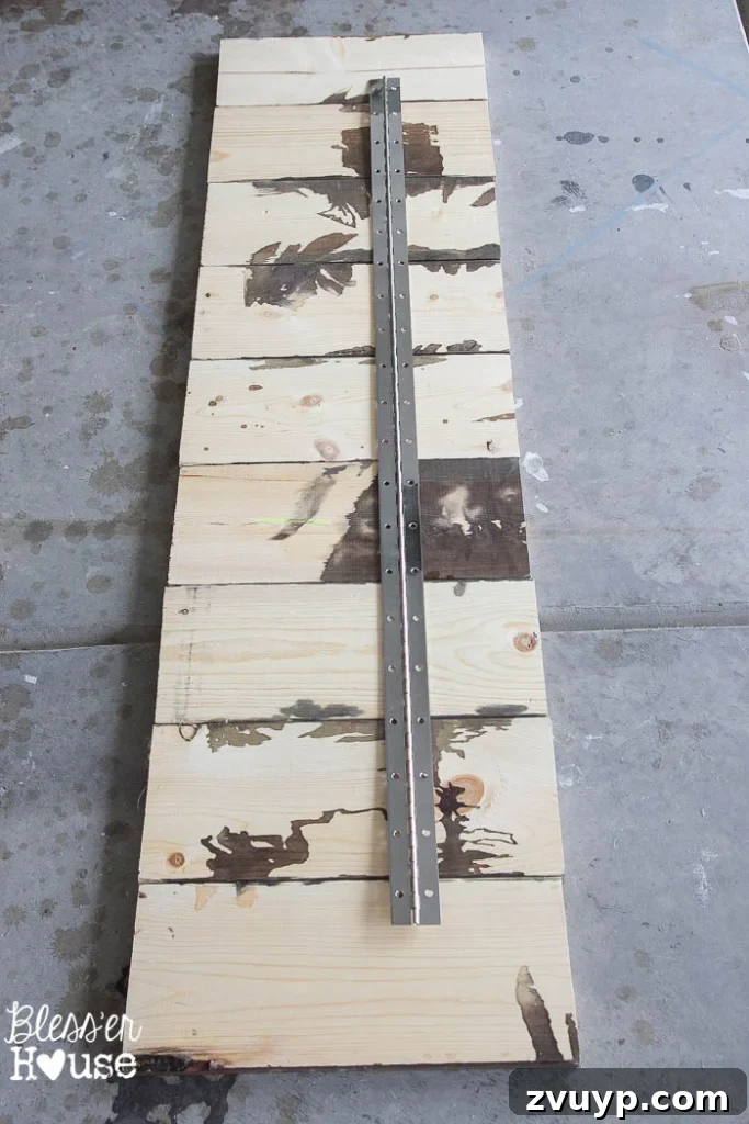 Upcycled Door Knob Towel Hooks 4 DIY Antique Door Knob Towel Rack | Bless'er House: Robert cutting the continuous hinge to size for the towel rack using a hacksaw.