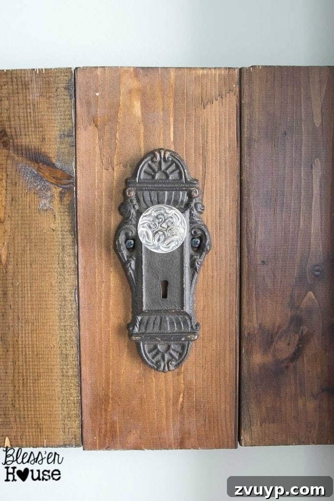 Upcycled Door Knob Towel Hooks 10 DIY Antique Door Knob Towel Rack | Bless'er House: Bronze antique-style door knobs on the towel rack, showing the varied aesthetic.