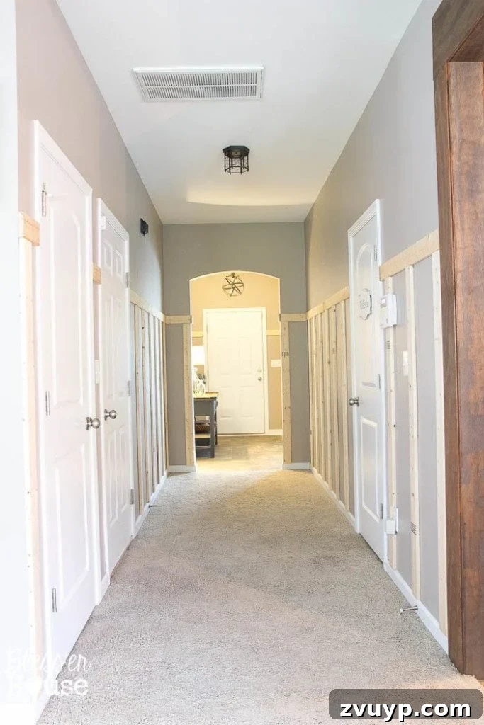 Effortless & Affordable Board and Batten DIY 19 Plain board and batten wainscoting installed in a hallway before any additional decorative shelf
