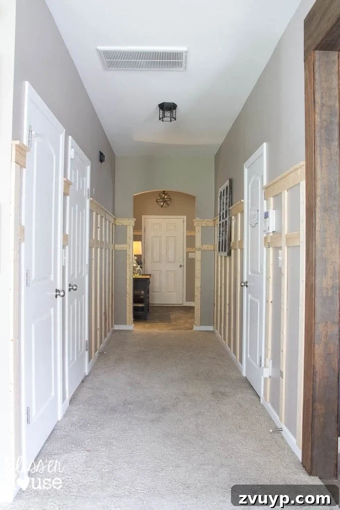 Effortless & Affordable Board and Batten DIY 20 Adding board and batten wainscoting to a dark hallway, with a new shelf detail on top