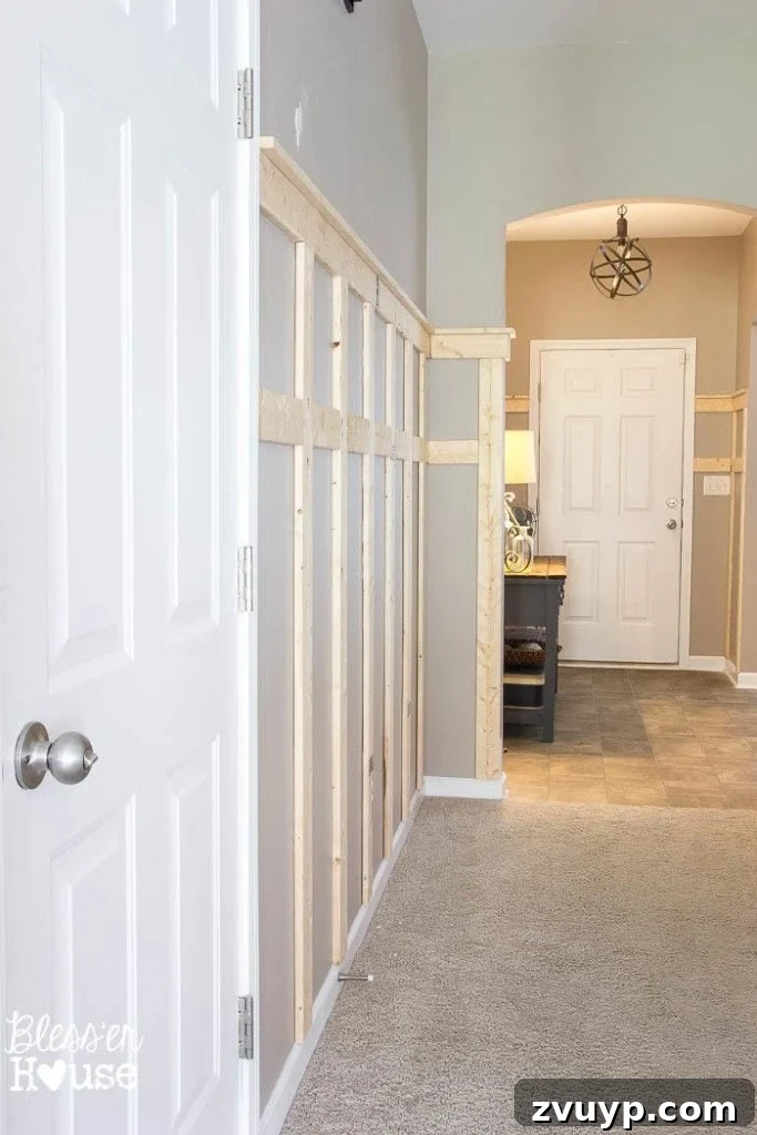 Effortless & Affordable Board and Batten DIY 21 Board and batten wainscoting installed before caulking and wood filling, showing visible gaps and nail holes