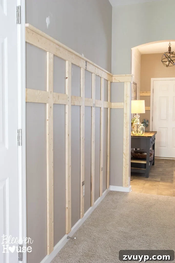 Effortless & Affordable Board and Batten DIY 22 Installed board and batten wainscoting awaiting paint, after caulking and wood filling