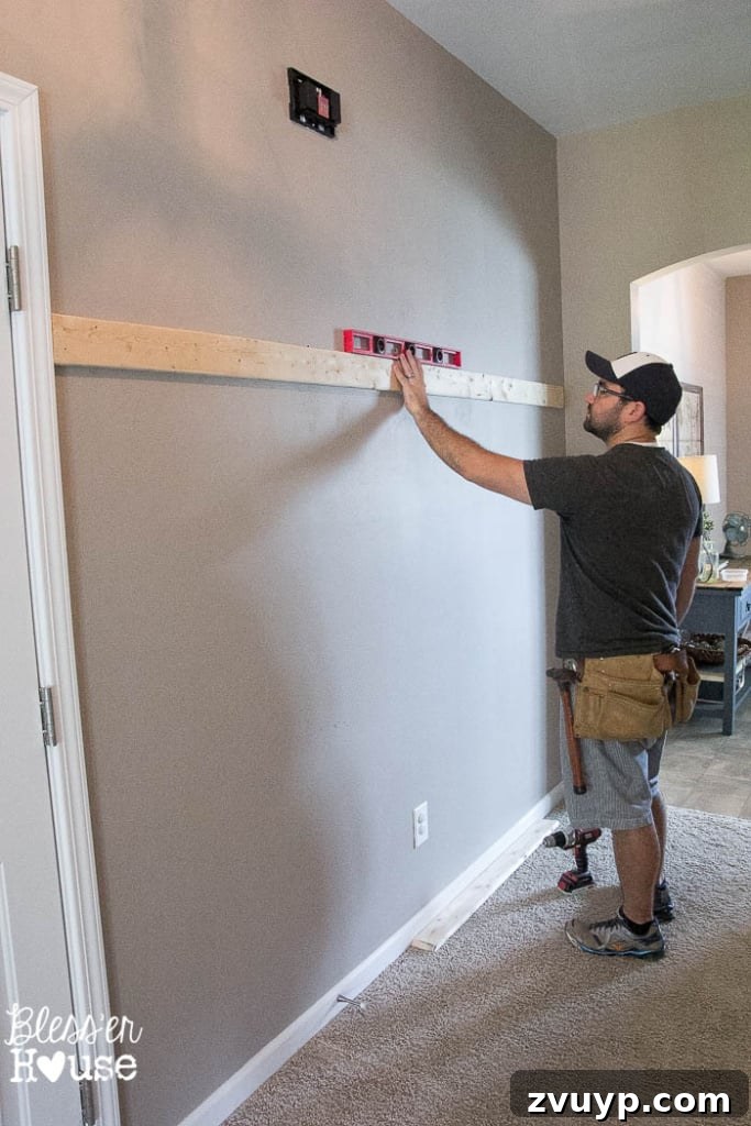 Effortless & Affordable Board and Batten DIY 10 Ensuring the top horizontal board of the board and batten is perfectly level