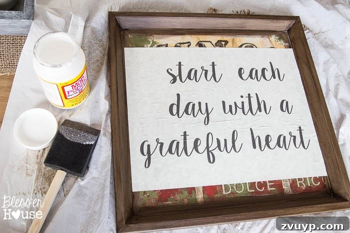 Transforming Old Art into Personalized Text Decor 7 Applying Mod Podge to adhere typography printables to frames