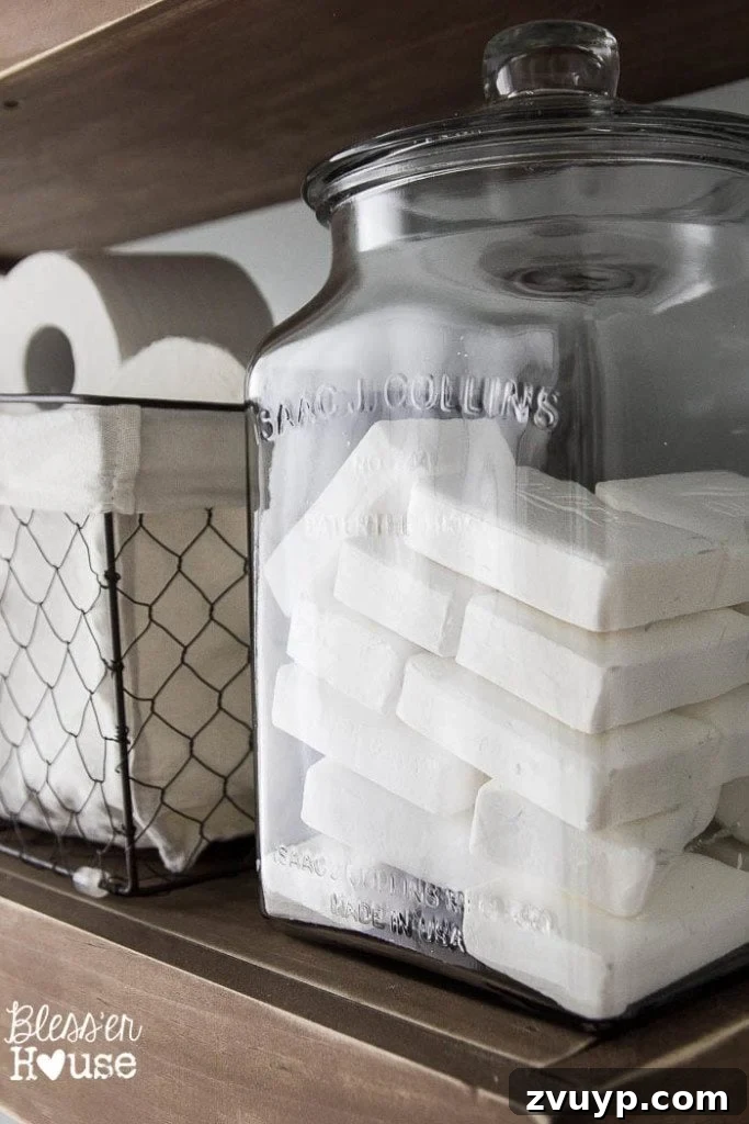 Chic Modern Farmhouse Bathroom Remodel Tour 13 Walmart finds: Chicken wire basket and glass jar for soaps, adding budget-friendly farmhouse organization.