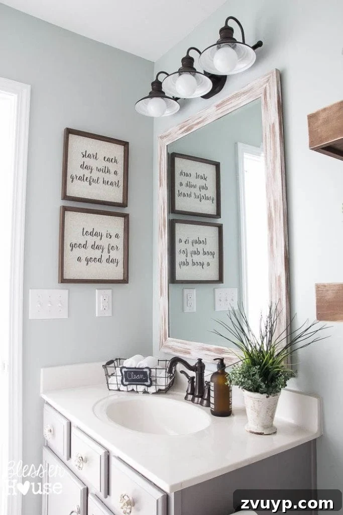 Chic Modern Farmhouse Bathroom Remodel Tour 15 Budget-friendly distressed white driftwood mirror, a key feature in the modern farmhouse bathroom makeover.
