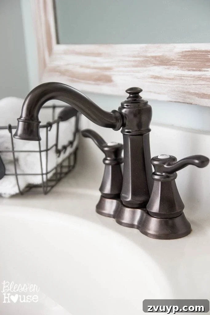 Chic Modern Farmhouse Bathroom Remodel Tour 20 Elegant Moen faucet, a sophisticated addition to the modern farmhouse bathroom vanity.