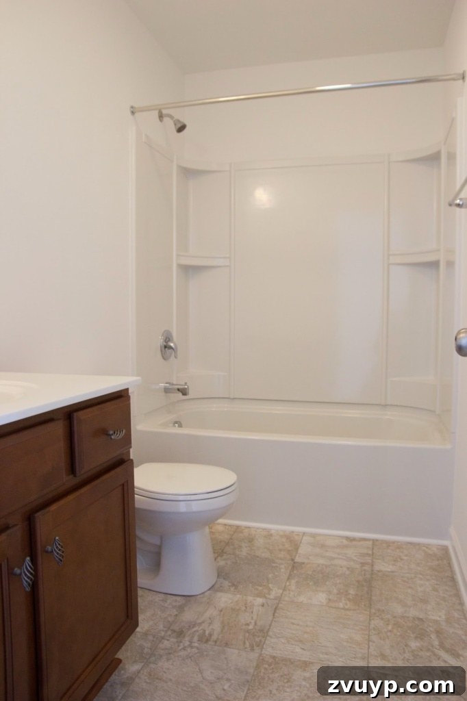 Chic Modern Farmhouse Bathroom Remodel Tour 2 Before: Generic builder-grade bathroom with standard fixtures and no distinctive style.