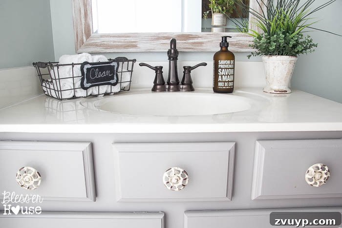 Chic Modern Farmhouse Bathroom Remodel Tour 22 Beautifully painted vanity cabinets with charming spigot knobs in the modern farmhouse bathroom.