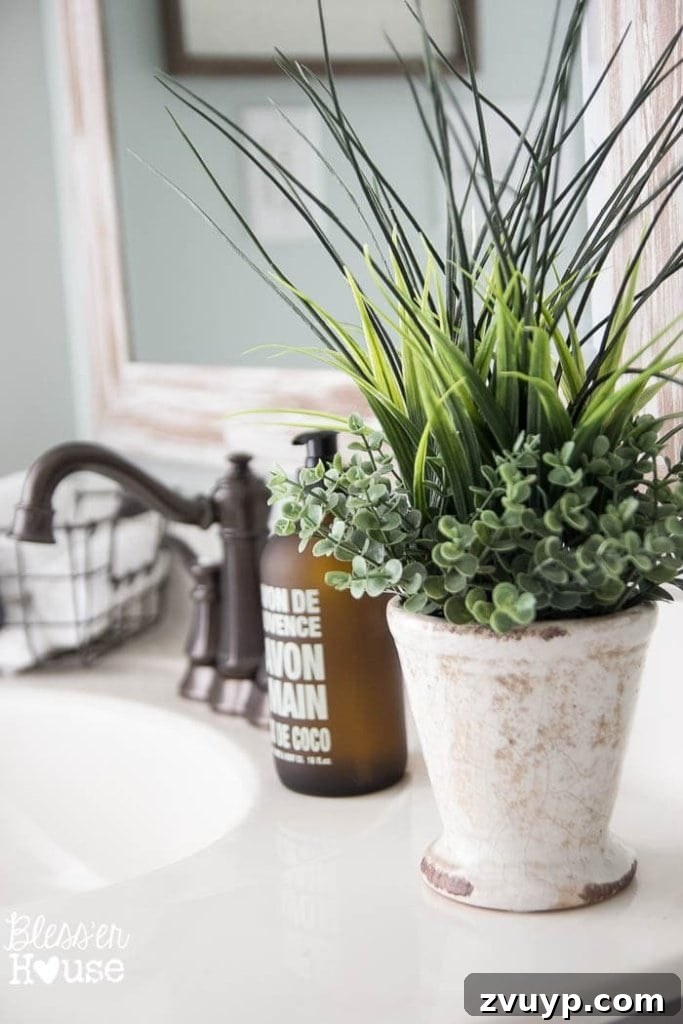 Chic Modern Farmhouse Bathroom Remodel Tour 23 Close-up of the vanity details: faucet, painted cabinet, and hardware in the modern farmhouse bathroom.