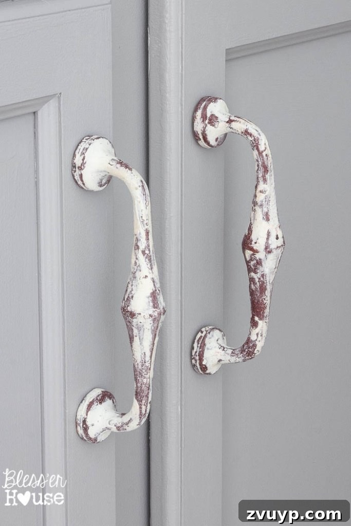 Chic Modern Farmhouse Bathroom Remodel Tour 24 New cabinet handles from Hobby Lobby perfectly complement the mirror in the farmhouse bathroom.