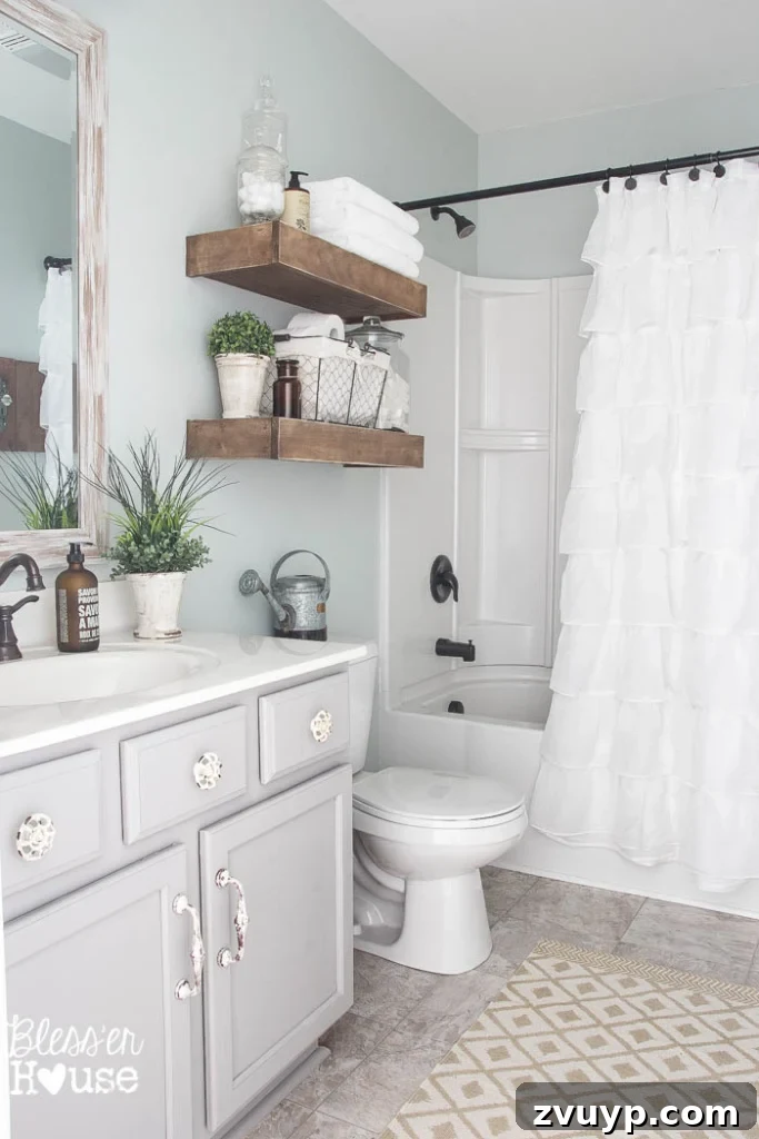 Chic Modern Farmhouse Bathroom Remodel Tour 25 Full view of the modernized farmhouse vanity with new paint, faucet, mirror, and hardware.
