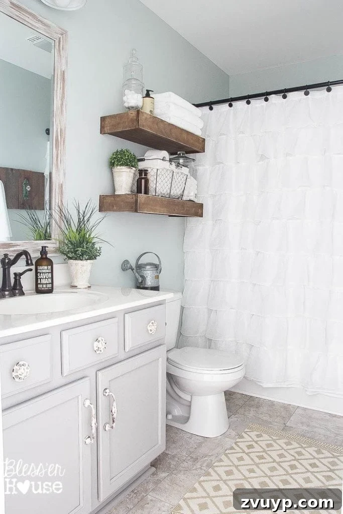 Chic Modern Farmhouse Bathroom Remodel Tour 5 After: First glimpse of the transformed modern farmhouse bathroom, featuring a ruffled shower curtain and unique decor.