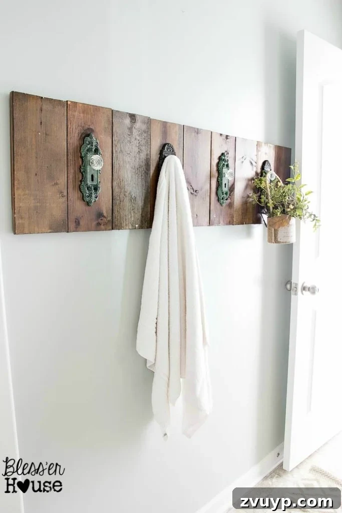 Chic Modern Farmhouse Bathroom Remodel Tour 8 Close-up of the antique doorknob hooks on the DIY towel rack, adding vintage flair to the farmhouse bathroom.