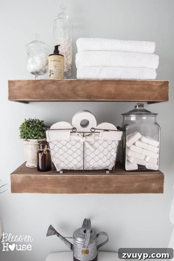 Chic Modern Farmhouse Bathroom Remodel Tour 10 Custom-built chunky rustic floating shelves in the modern farmhouse bathroom, perfect for display and storage.
