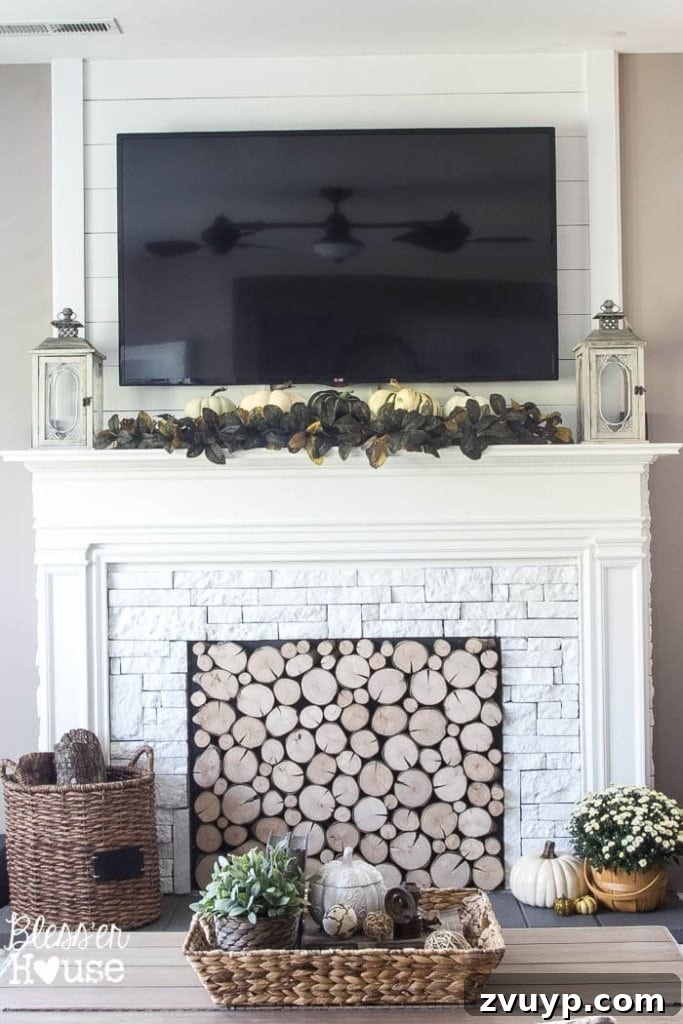 Elevate Your Mantel: Smart Ways to Conceal Electronics 7 Another view of a fall-decorated mantel with lanterns and other seasonal accents, cleverly integrating a TV into the decor.