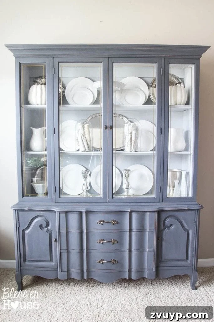 French Provincial Elegance Renewed 10 Close-up of the displayed white china and decorative items in the finished china cabinet