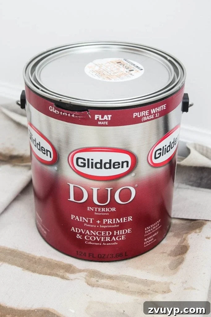 The Budget Hack for Designer Paint Colors 3 Close-up of a Glidden paint can with a custom-mixed Benjamin Moore 'Moonshine' label.