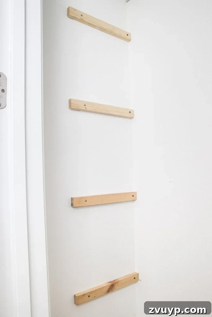 Quick and Easy DIY Closet Shelves 5 Installing side support strips for basic DIY closet shelving, secured with screws and drywall anchors. A key step for a beginner home improvement project to replace wire shelves.