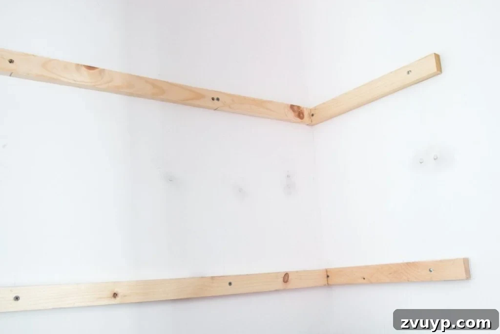 Quick and Easy DIY Closet Shelves 6 Installing back wall support strips for DIY closet shelves, connecting the side supports for a sturdy frame. A crucial step for a beginner home improvement project.