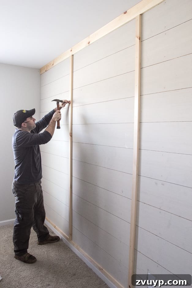 How to Build Your Own Planked Board and Batten Accent Wall Part 1 7 Installing vertical battens on DIY accent wall